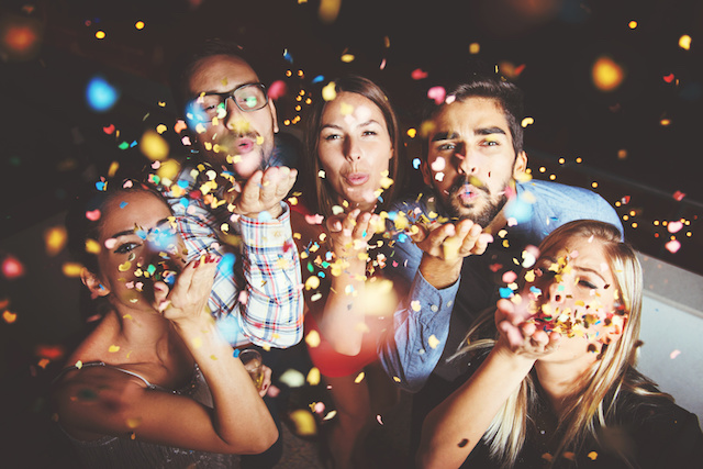 Group of people having a party, blowing confetti - Berlin ...