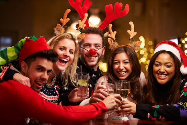 Group Of Friends Enjoying Christmas Drinks In Bar